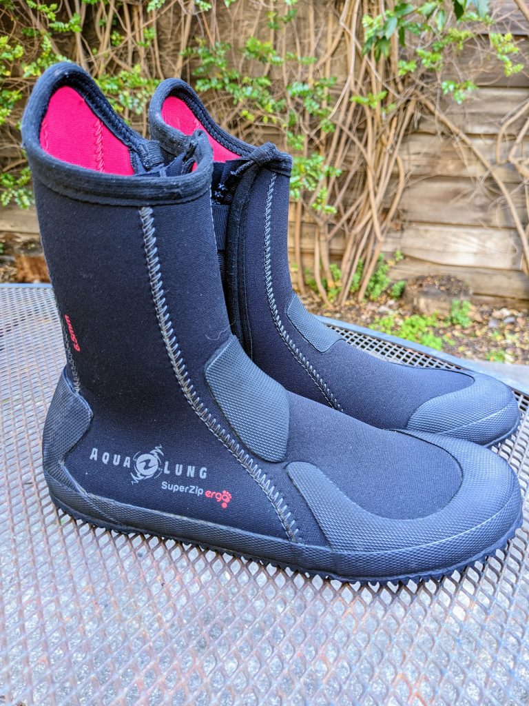 A pair of scuba diving boots, with zippers on the side.