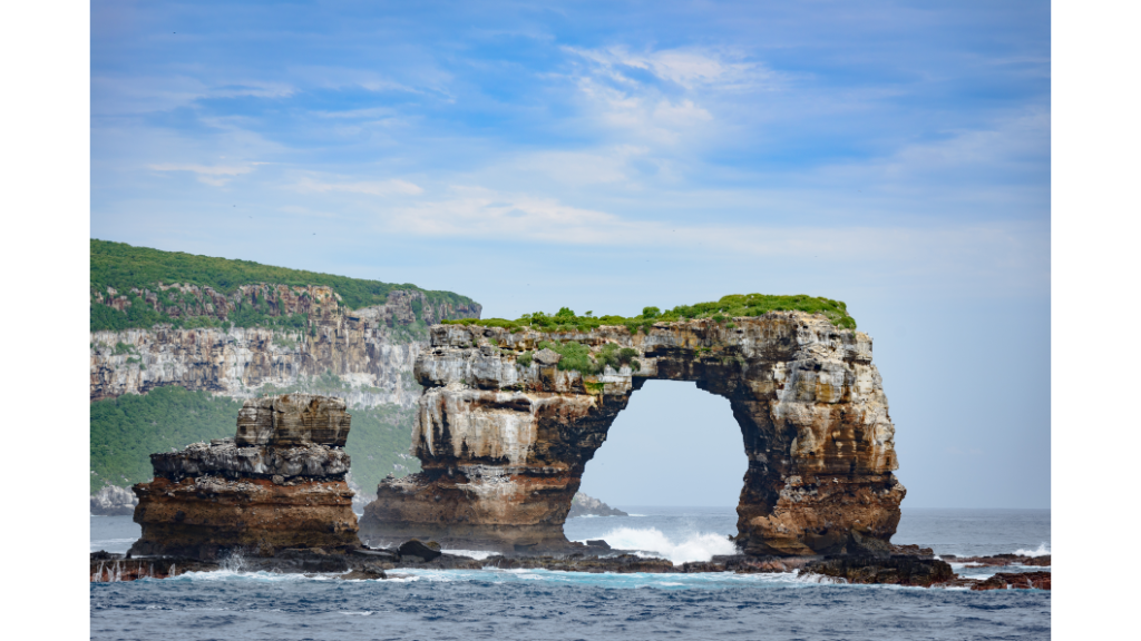 A natural arch of rock with moss on top in Galapagos Islands.